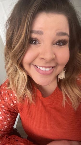 Smiling woman with ombre hair wearing a textured orange top — Erika Bandilla, Owner at Flourish Counseling