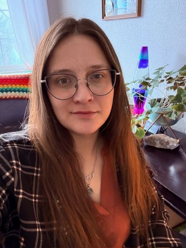 Young woman with glasses and long brown hair — Katie Eastman, LISW at Flourish Counseling